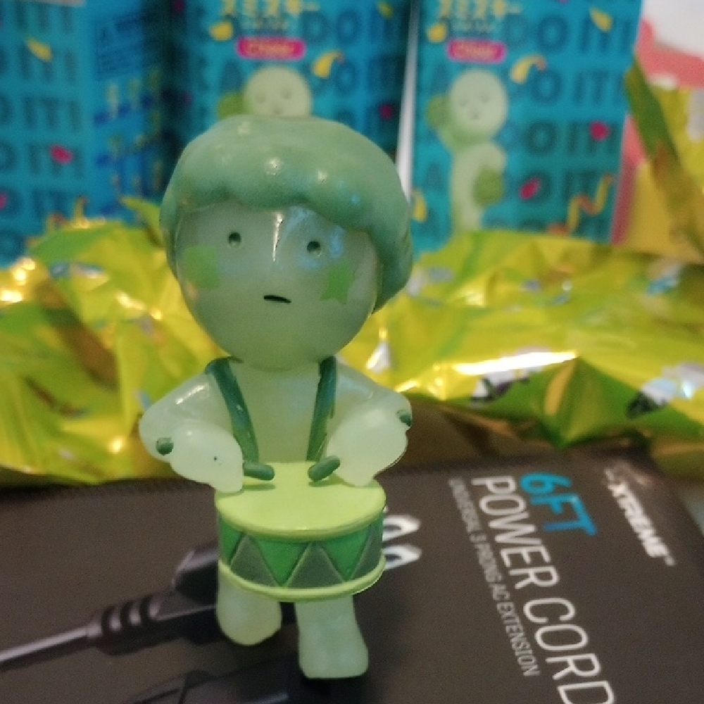 Playful Green Drummer Figurine